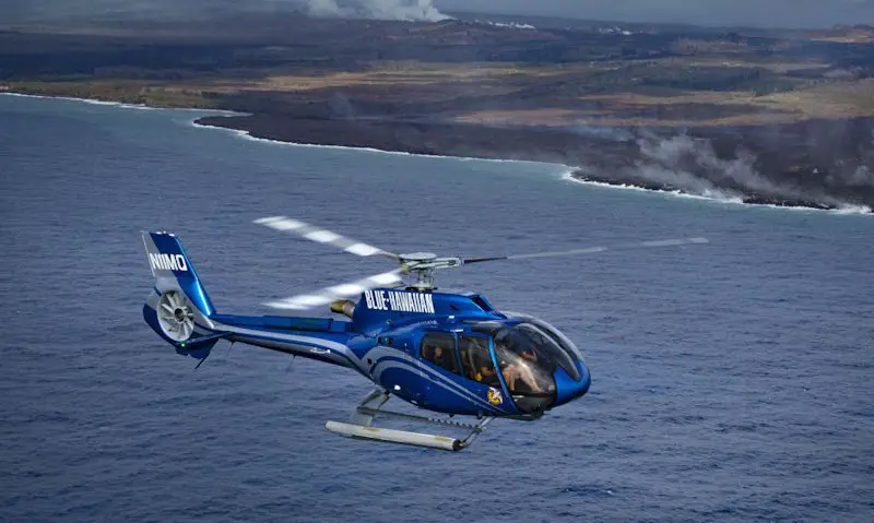 Blue Hawaiian Airbus EC130 soar above Big Island coast